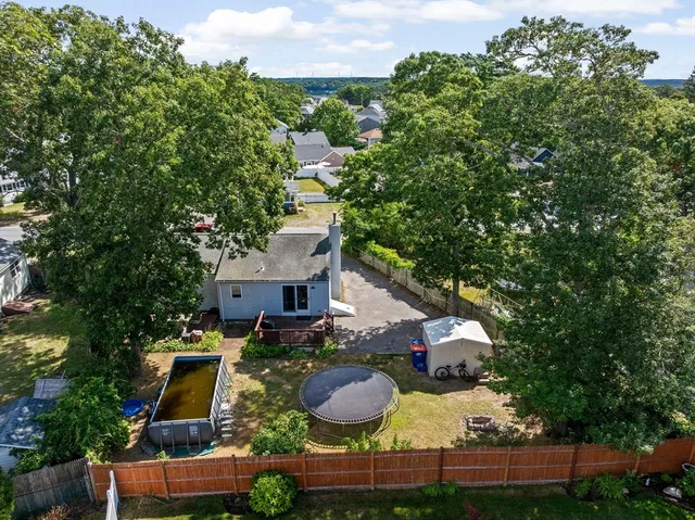 an aerial view of a house with yard swimming pool and outdoor seating