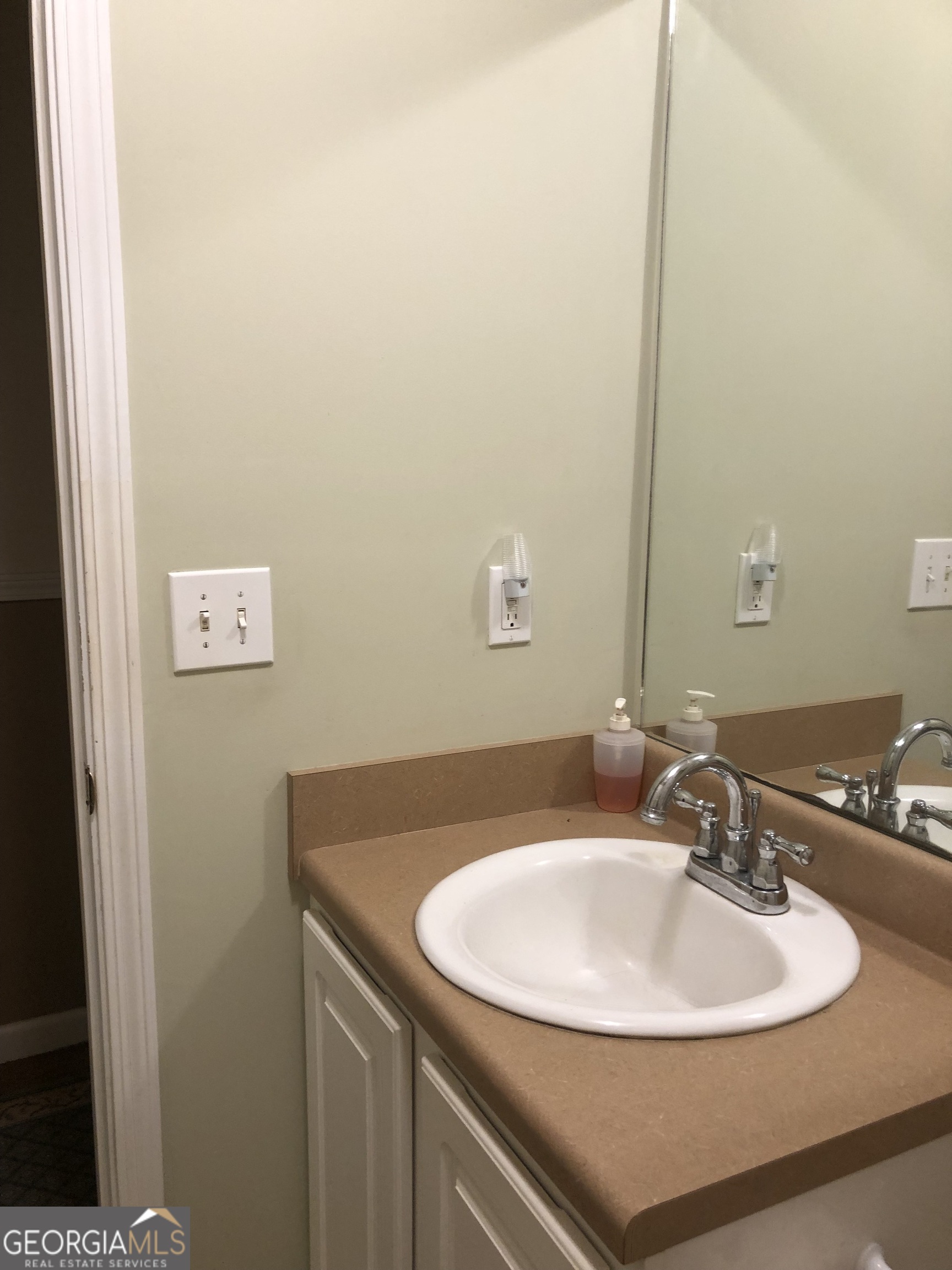 1744 Campbell Road Covington, GA 30014 - Photo 13 of 25 a bathroom with a sink and a mirror