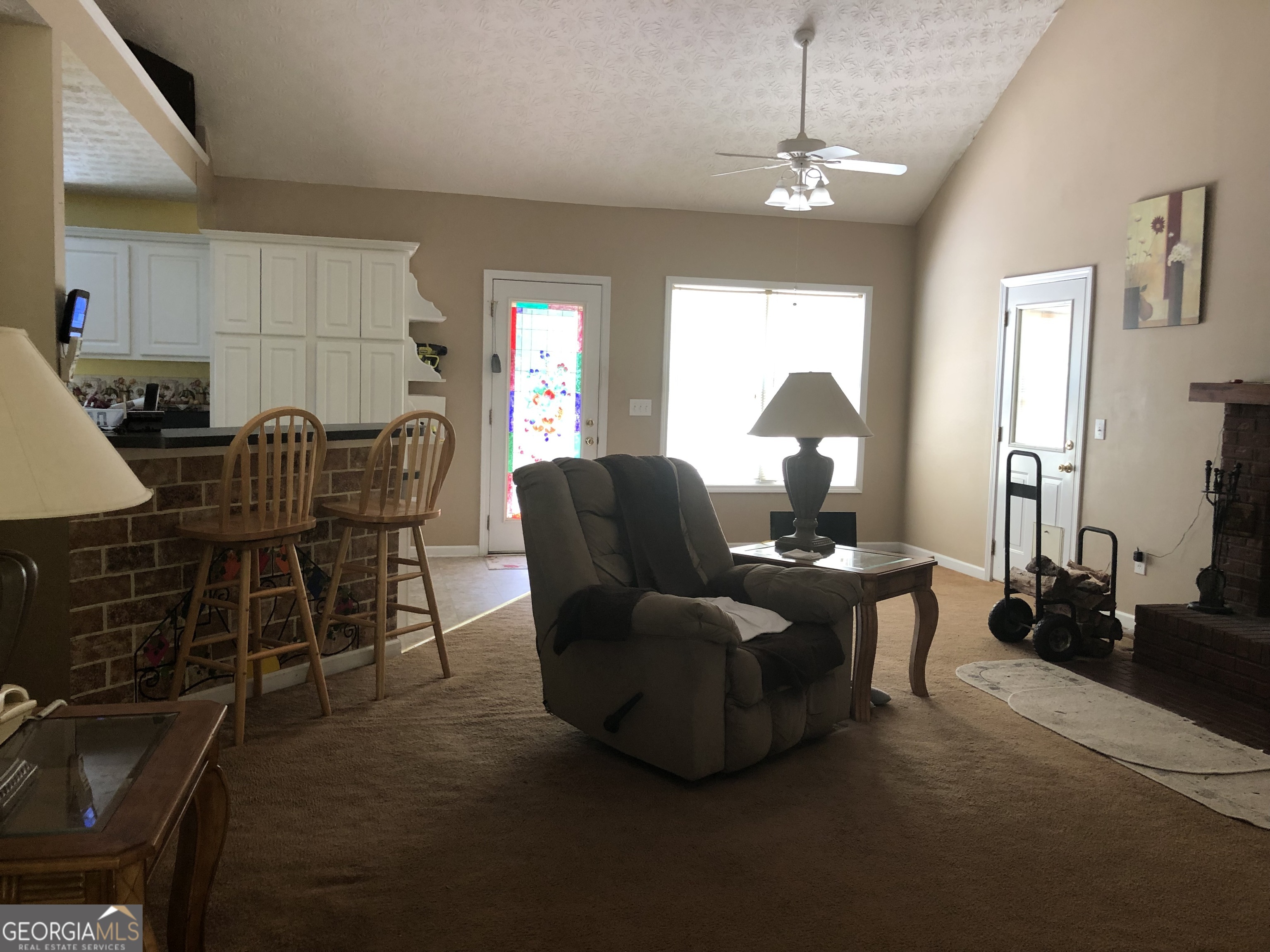 1744 Campbell Road Covington, GA 30014 - Photo 3 of 25 a living room with furniture a chandelier and a window