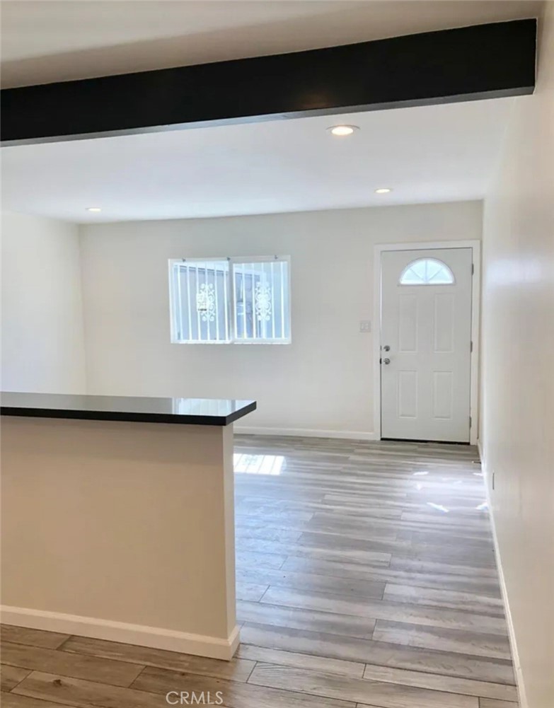 352 West Peach Street Compton, CA 90222 - Photo 6 of 9 a view of an empty room with wooden floor and a window