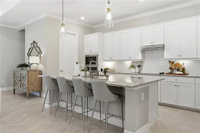 a kitchen with white cabinets and white appliances