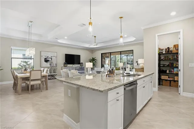 a kitchen with stainless steel appliances granite countertop a sink a stove a microwave a center island and cabinets