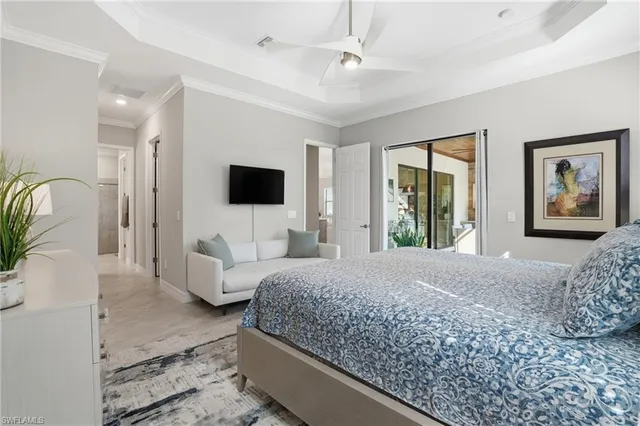 a bedroom with a large bed and a flat screen tv