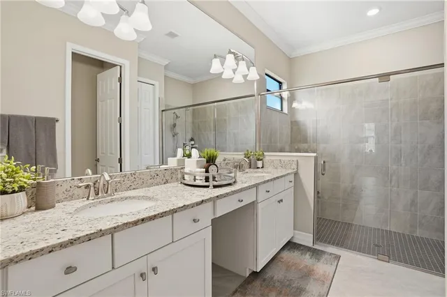 a bathroom with a granite countertop sink a mirror and a shower