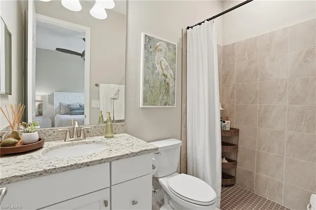 a bathroom with a granite countertop sink toilet and shower