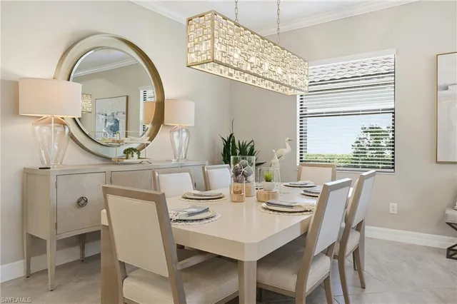a view of a dining room with furniture and a chandelier