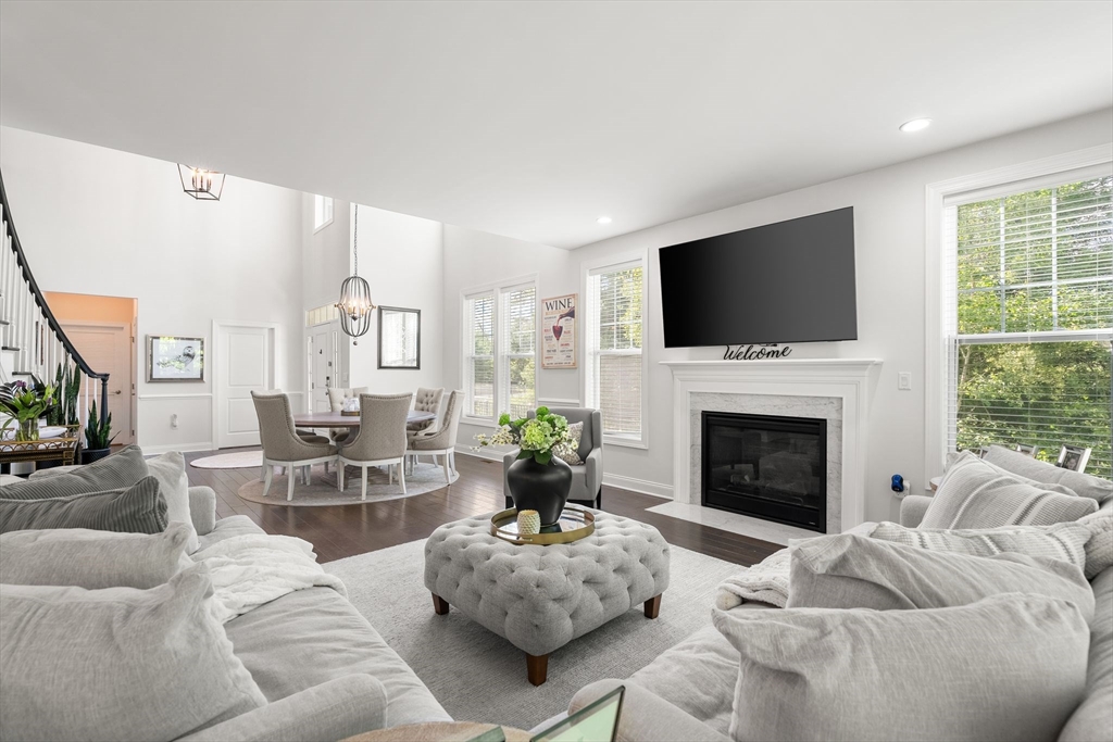 2 Hummingbird Way, Unit 1 Methuen, MA 01844 - Photo 8 of 42 a living room with furniture a fireplace and a flat screen tv