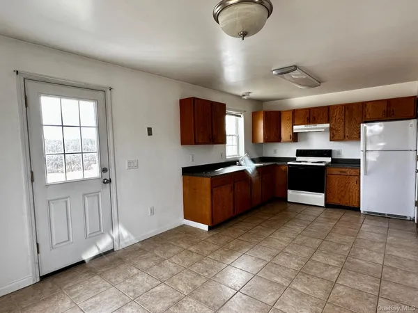 a kitchen with stainless steel appliances granite countertop a stove top oven a sink and a granite counter tops