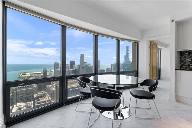 a view of an empty room with glass door and balcony