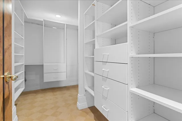 a view of an empty room with a fireplace and a large window