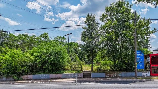 a view of a city with lush green forest