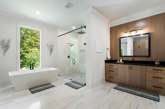 a view of a kitchen with refrigerator stove and wooden cabinets