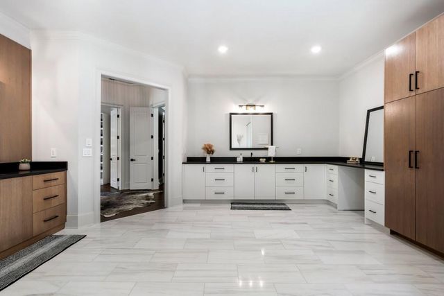 a living room with lots of furniture and a walk in closet