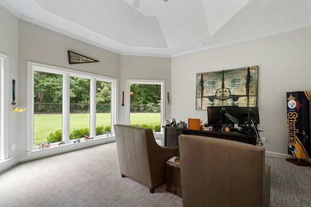 a view of deck with furniture and barbeque oven in the backyard