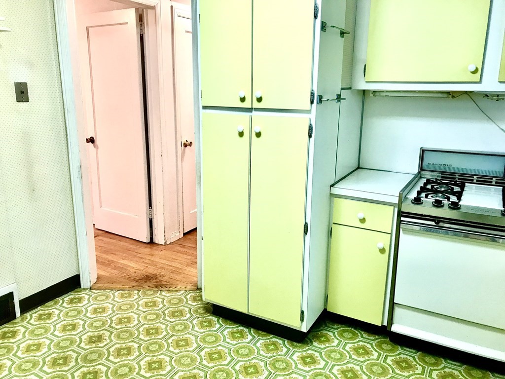66 Burnside Terrace Springfield, MA 01118 - Photo 11 of 29 a kitchen with a refrigerator and a stove
