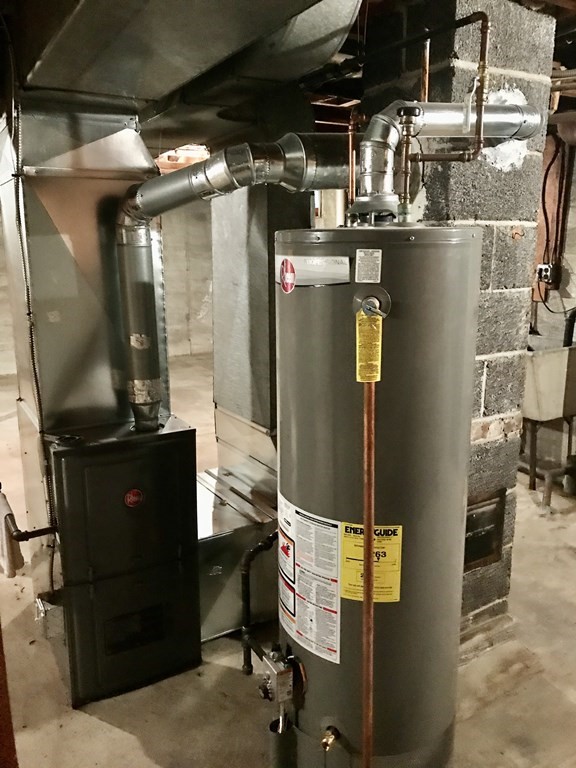 66 Burnside Terrace Springfield, MA 01118 - Photo 28 of 29 a room with water heater and wooden cabinets