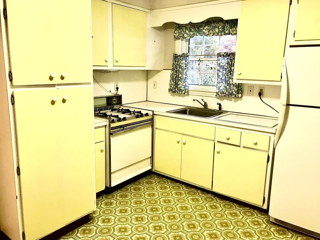66 Burnside Terrace Springfield, MA 01118 - Photo 10 of 29 a kitchen with a sink a stove top oven