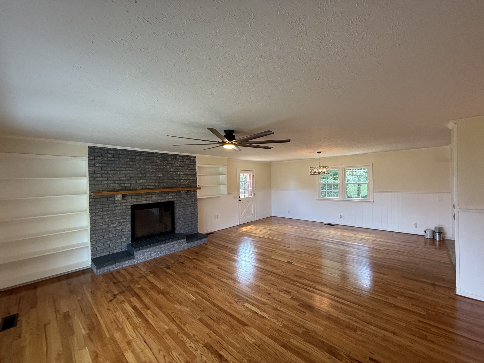 244 James Stafford Road Gainesboro, TN 38562 - Photo 10 of 39 wooden floor in an empty room with a fireplace