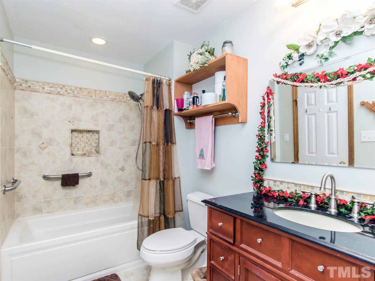 4501 Cobbler Place Raleigh, NC 27613 - Photo 14 of 25 a bathroom with a bath tub sink mirror vanity and toilet
