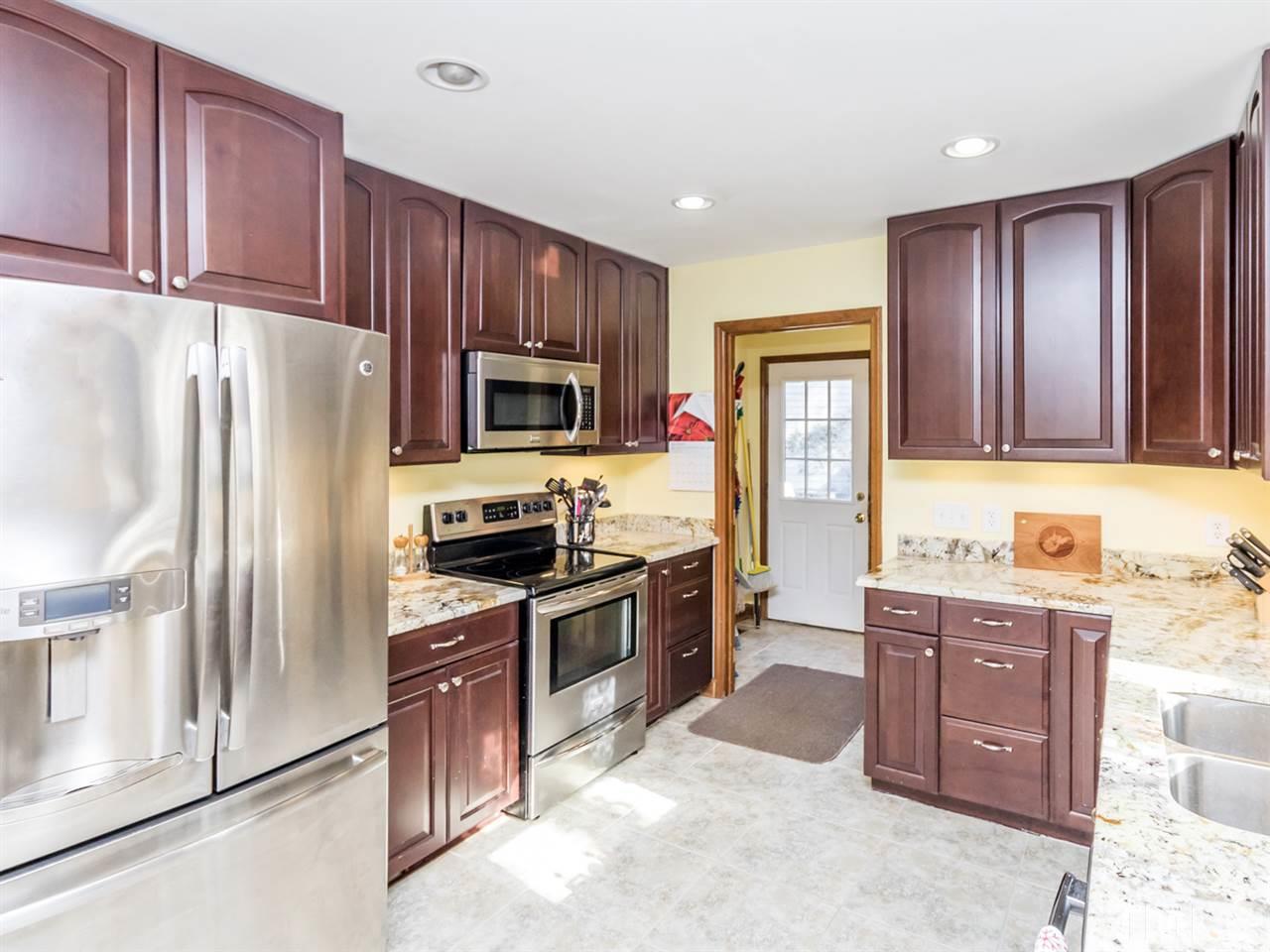 4501 Cobbler Place Raleigh, NC 27613 - Photo 8 of 25 a kitchen with stainless steel appliances granite countertop a refrigerator stove and sink