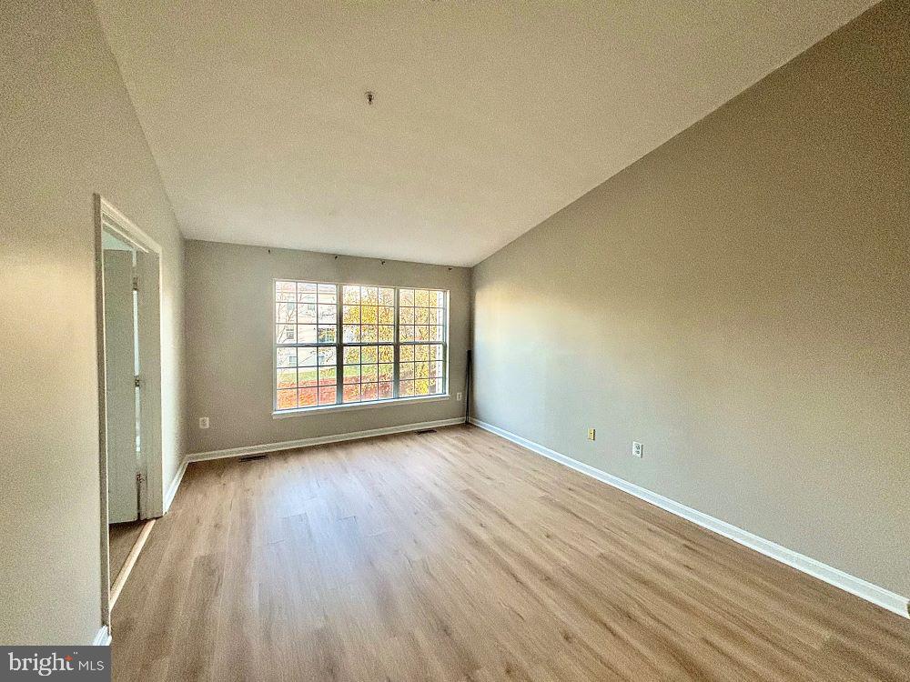 12411 Carters Grove Place Silver Spring, MD 20904 - Photo 6 of 11 a view of an empty room with wooden floor and a window