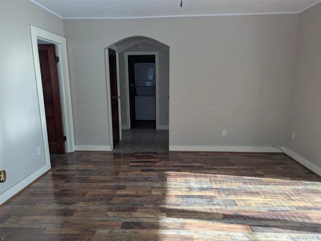 a view of room with window and wooden floor