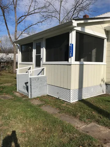 a view of house with a yard