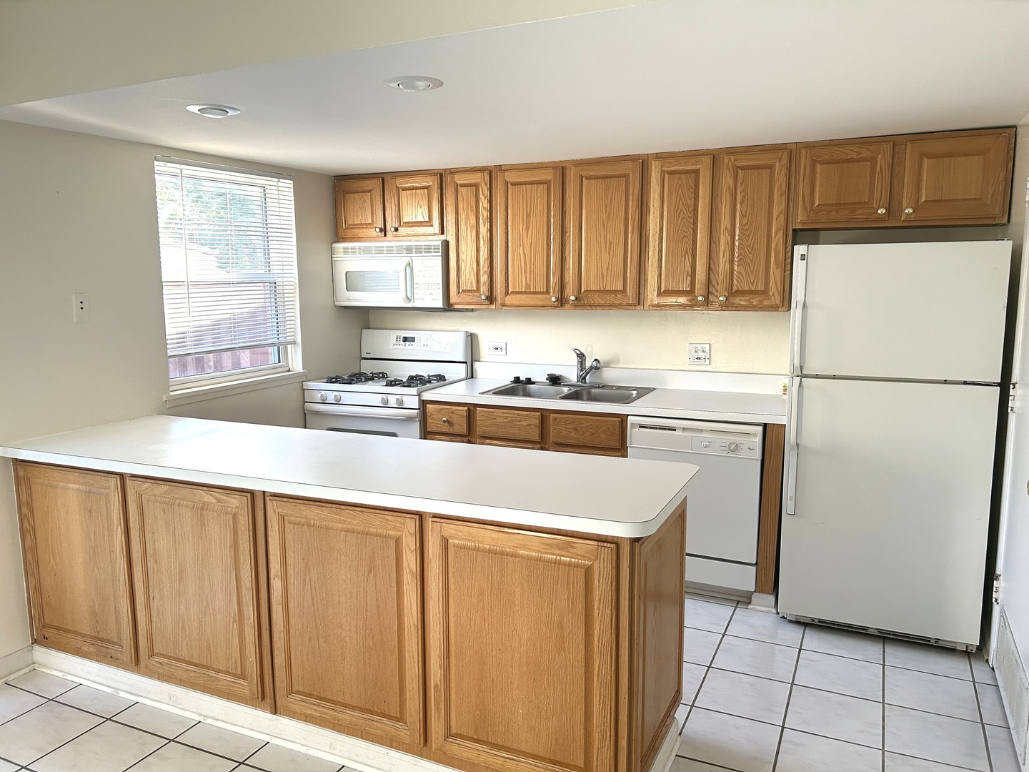 1776 Hassell Road Hoffman Estates, IL 60169 - Photo 4 of 23 a kitchen with a refrigerator a sink and cabinets