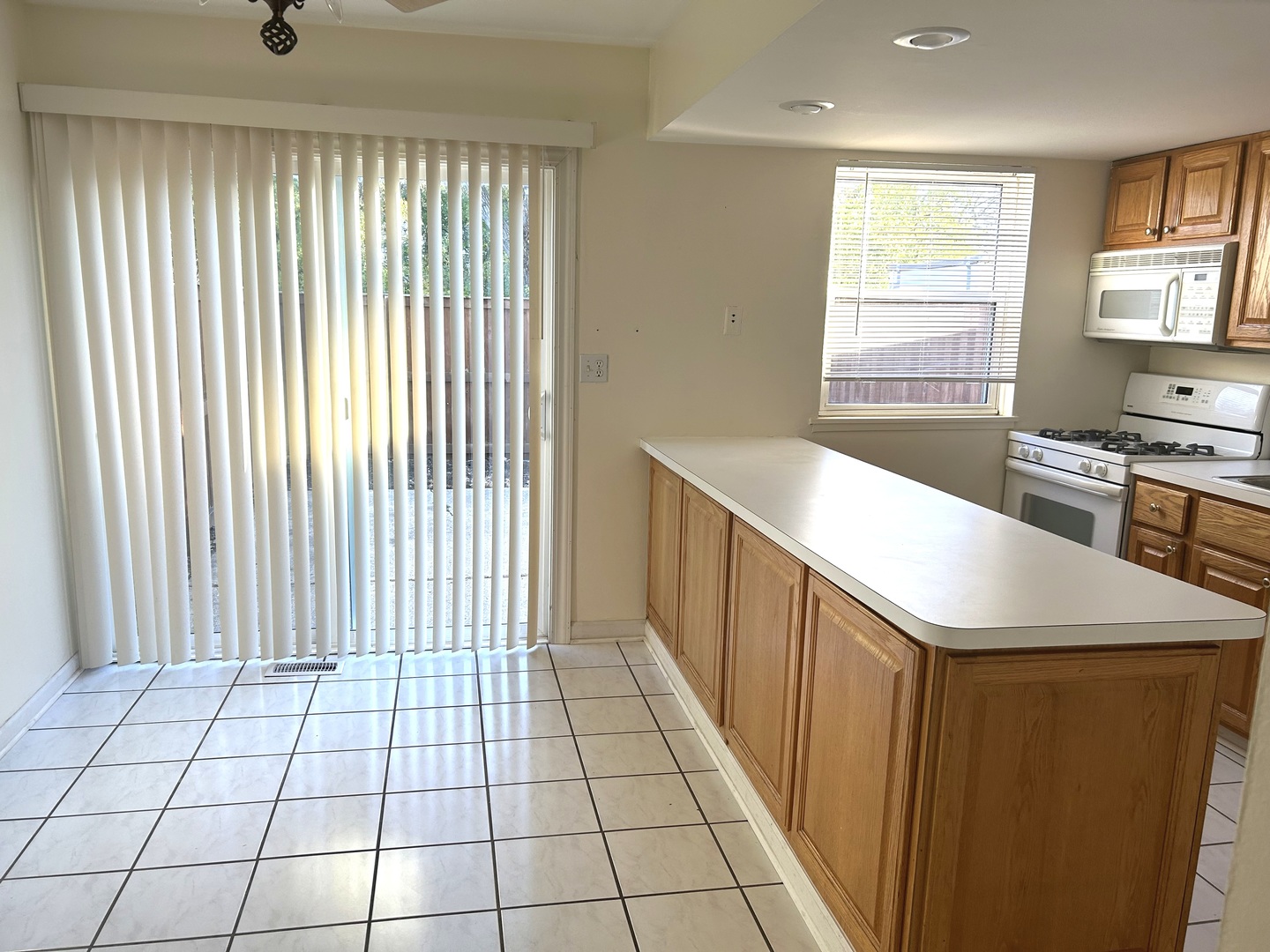 1776 Hassell Road Hoffman Estates, IL 60169 - Photo 5 of 23 a kitchen with a sink a stove cabinets and a dining table