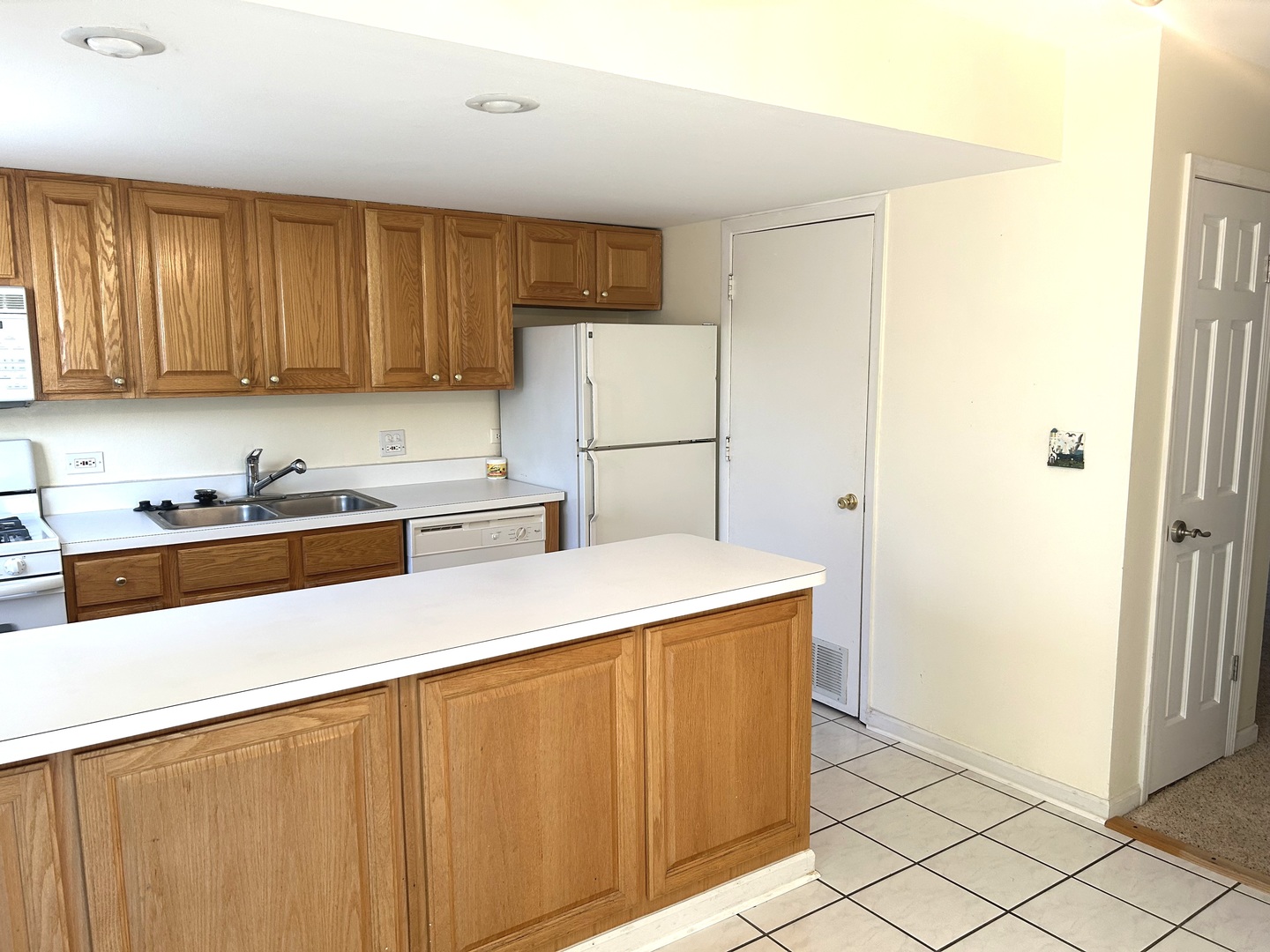 1776 Hassell Road Hoffman Estates, IL 60169 - Photo 6 of 23 a kitchen with a sink a stove and a refrigerator