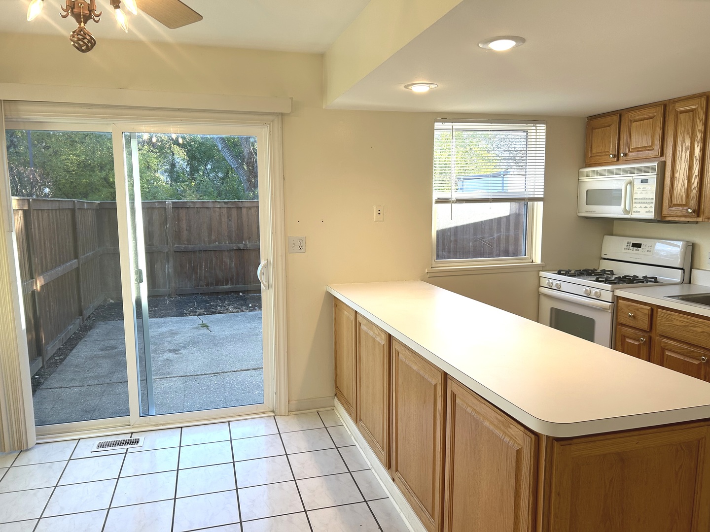 1776 Hassell Road Hoffman Estates, IL 60169 - Photo 7 of 23 a kitchen with a sink a refrigerator and cabinets