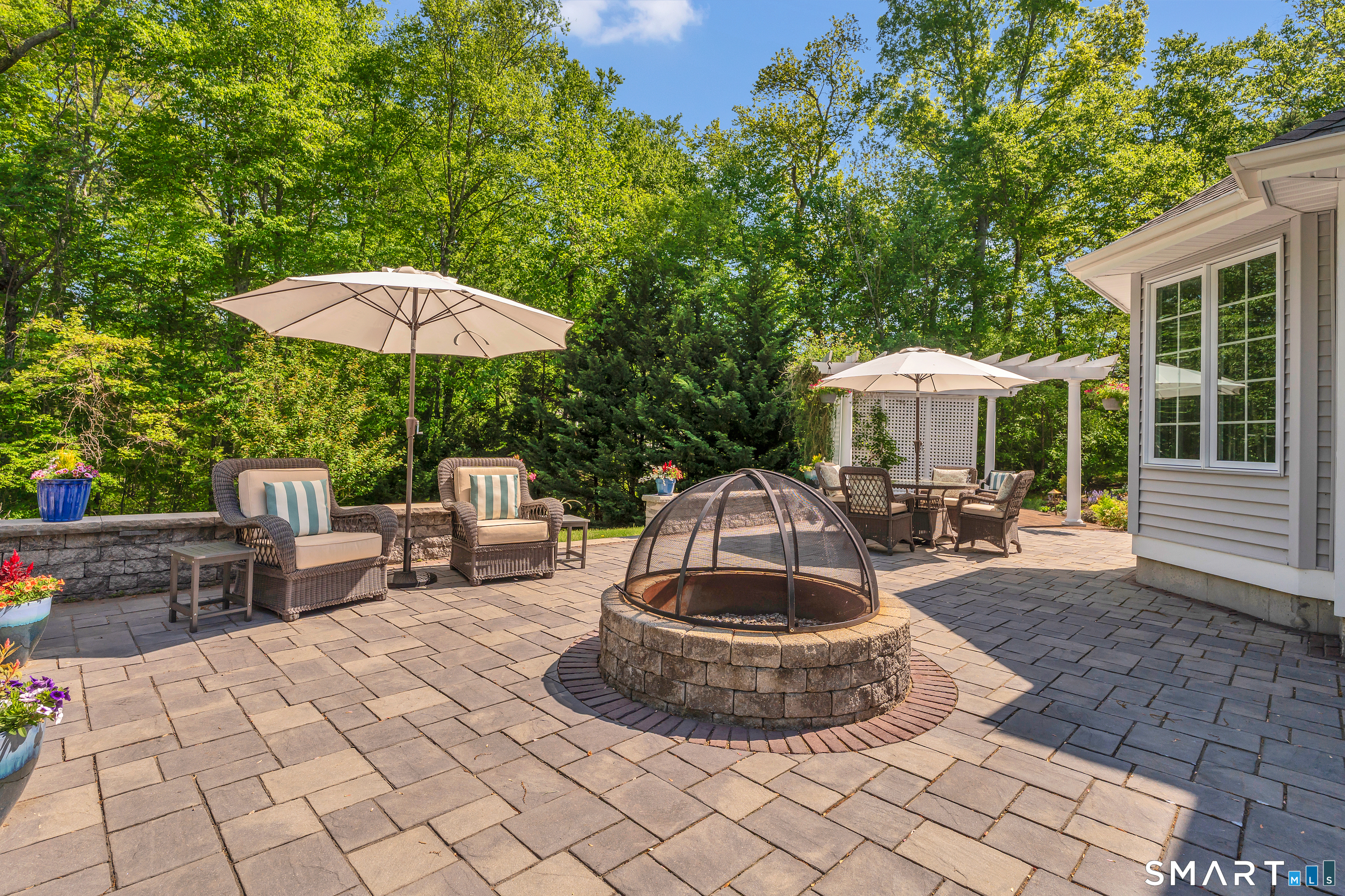 21 Stone Wall Road Salem, CT 06420 - Photo 35 of 38 a view of a patio with a table and chairs under an umbrella