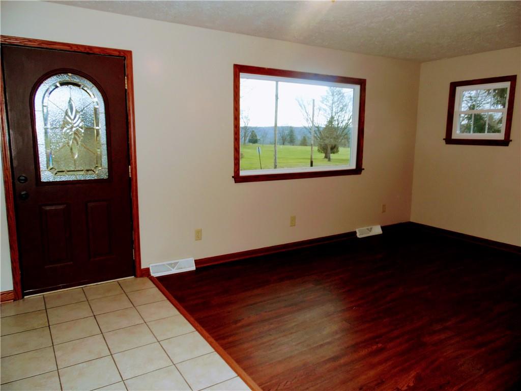 497 Tanglewood Road Pulaski, PA 16143 - Photo 3 of 20 a view of an empty room with wooden floor and windows