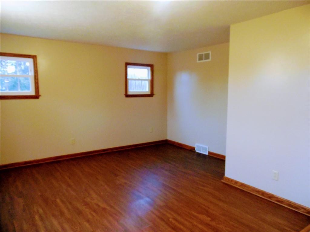 497 Tanglewood Road Pulaski, PA 16143 - Photo 4 of 20 a view of an empty room with wooden floor and a window
