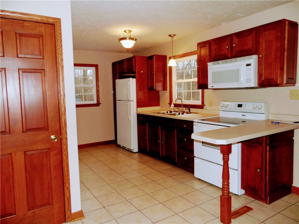 497 Tanglewood Road Pulaski, PA 16143 - Photo 5 of 20 a kitchen with a sink stove and cabinets