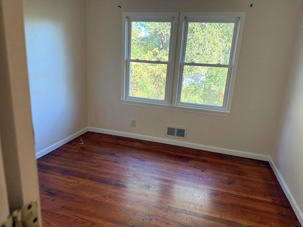 106 Flippen Road Stockbridge, GA 30281 - Photo 12 of 16 an empty room with wooden floor and windows
