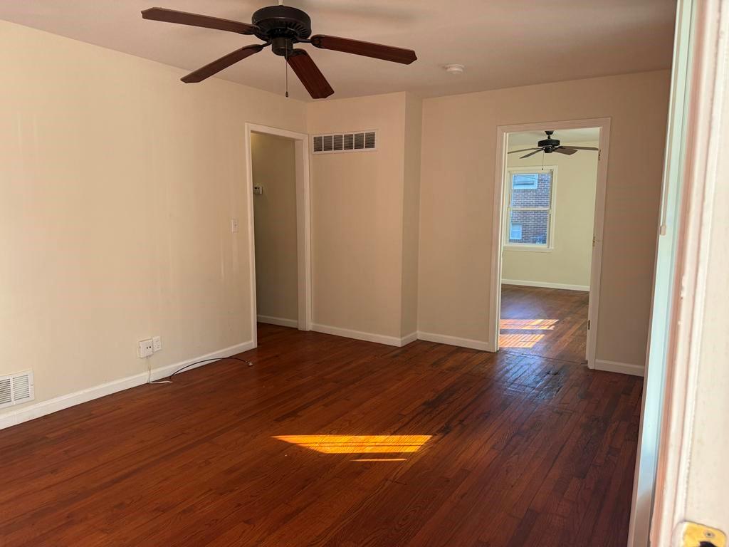 106 Flippen Road Stockbridge, GA 30281 - Photo 5 of 16 an empty room with wooden floor and windows