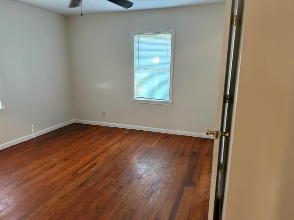 106 Flippen Road Stockbridge, GA 30281 - Photo 6 of 16 an empty room with wooden floor and windows