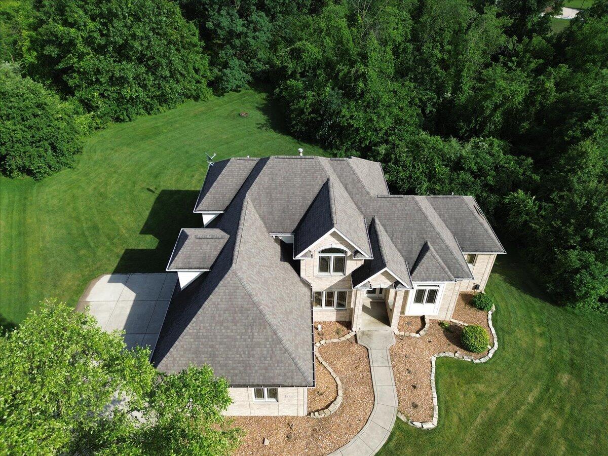 8751 Bridgewater Court Crown Point, IN 46307 - Photo 11 of 49 an aerial view of a house with outdoor space and trees all around
