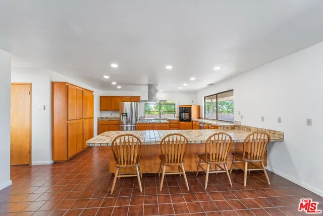 a large kitchen with a table and chairs