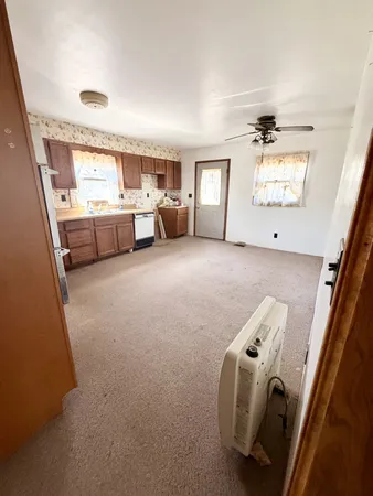 a open kitchen with granite countertop a sink and a stove