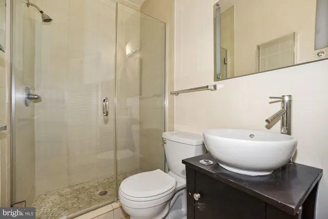 a bathroom with a toilet a sink and a shower