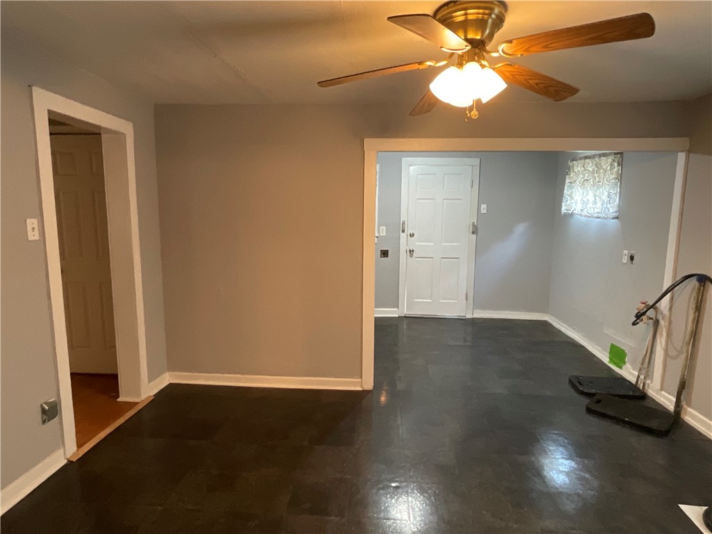 2507 Morris Street Corpus Christi, TX 78405 - Photo 3 of 16 an empty room with wooden floor chandelier fan and windows
