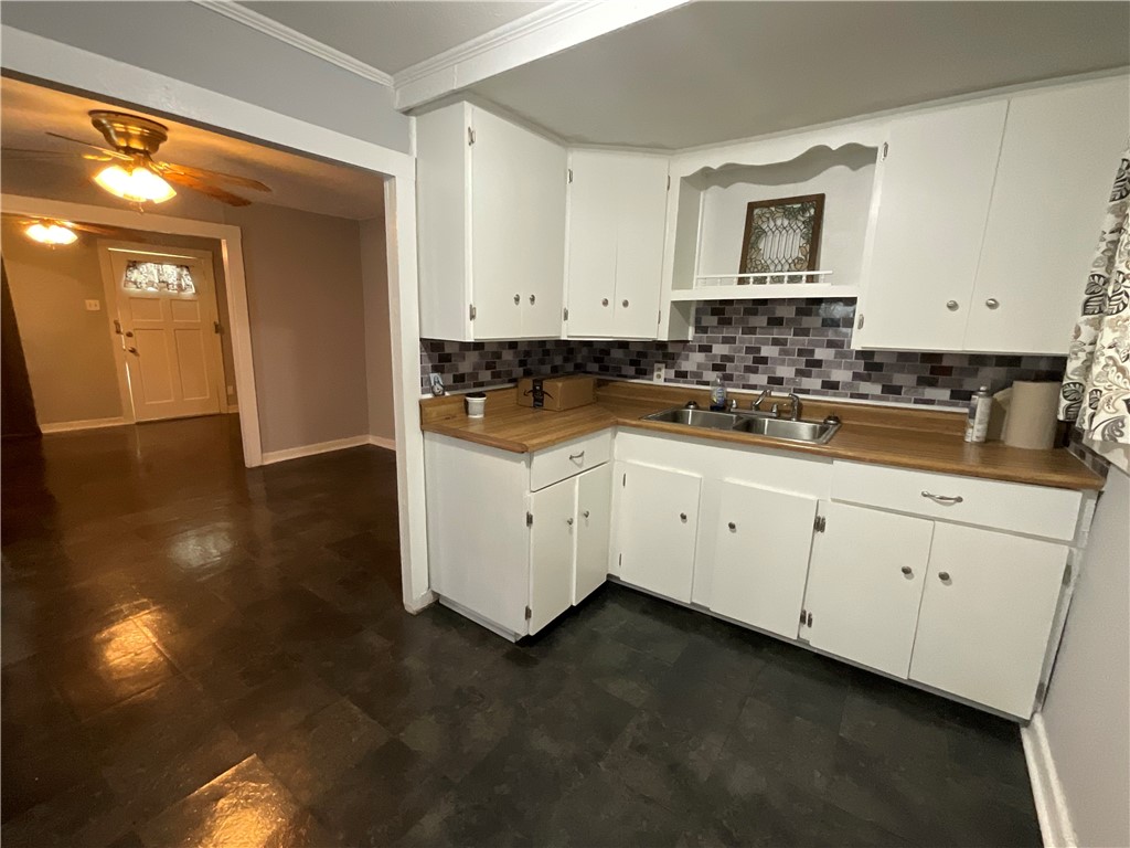 2507 Morris Street Corpus Christi, TX 78405 - Photo 7 of 16 a kitchen with granite countertop white cabinets and sink