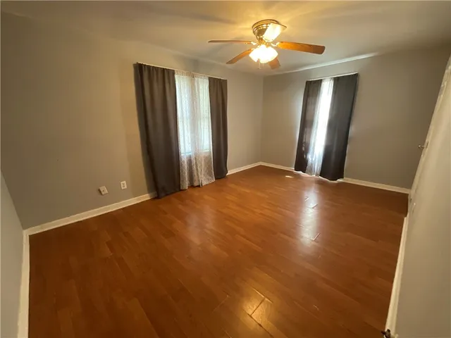 a view of a hallway with a chandelier fan