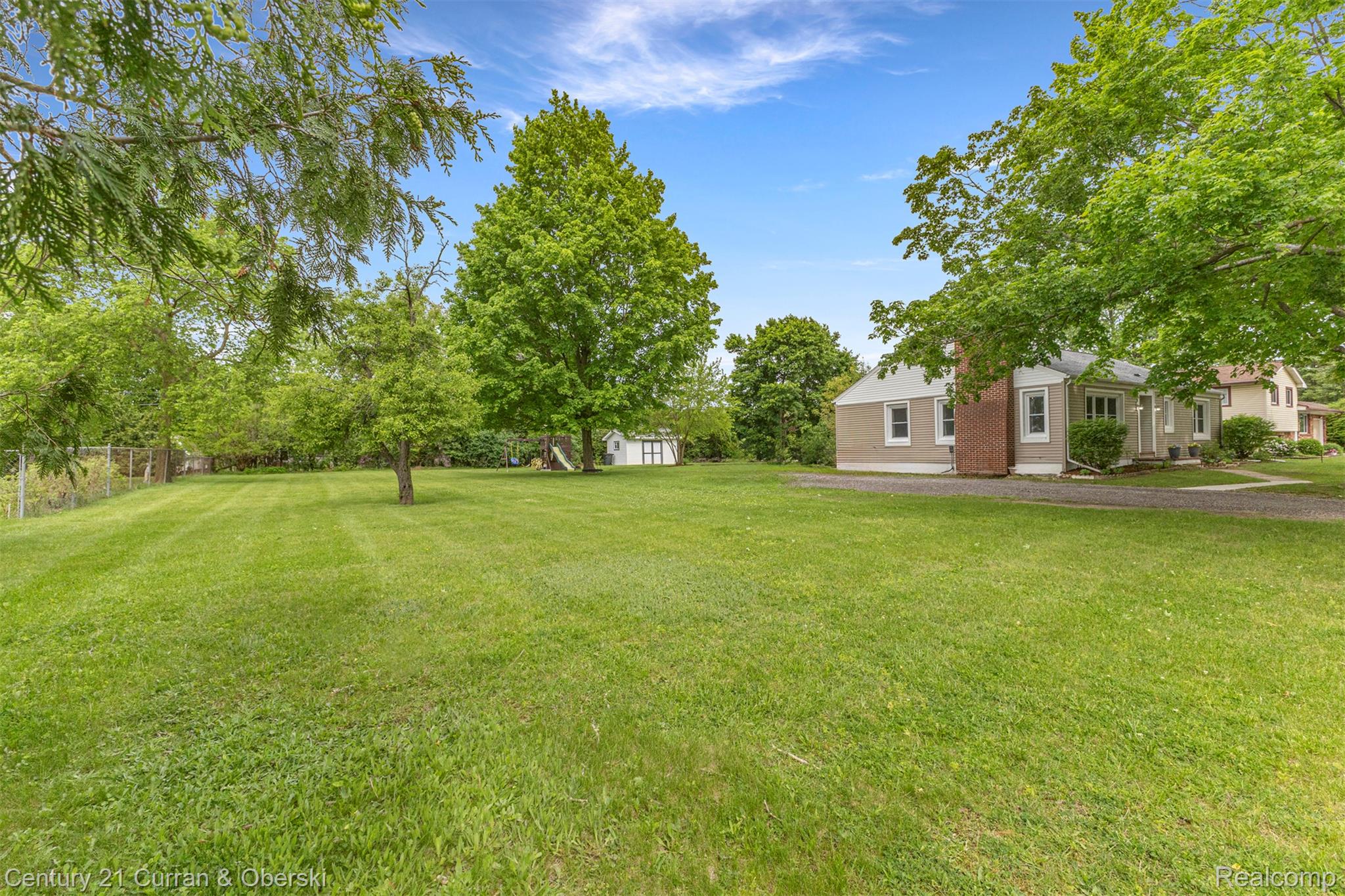 411 South Adrian Street Tecumseh, MI 49286 - Photo 45 of 61 View of yard featuring view of wooded area