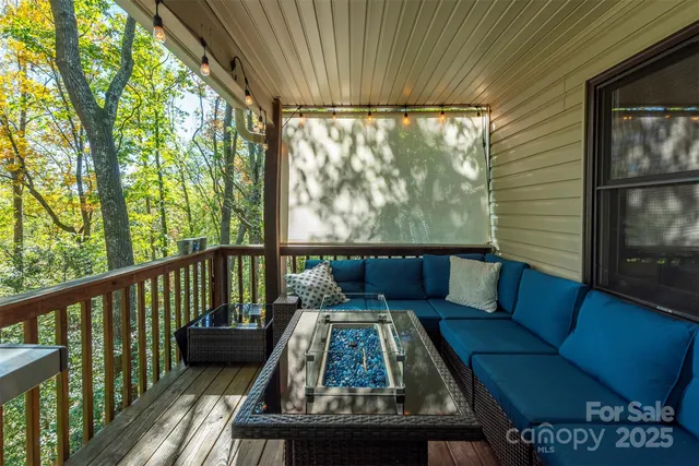 a view of a deck with two couches and pool with wooden floor