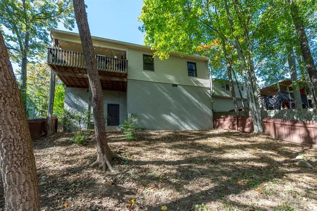 a front view of a house with yard and trees