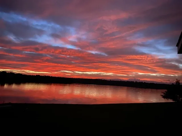 a view of lake with sunset