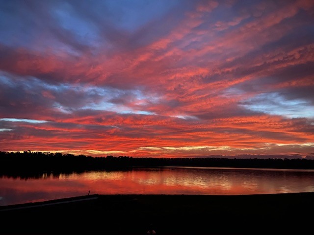 12 Walnut Bend Huntsville, TX 77320 - Photo 16 of 16 a view of lake with sunset